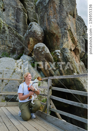 Woman Hiking with Dog on Mountain Trail Woman Hiking with Dog on Mountain Trail 136955336