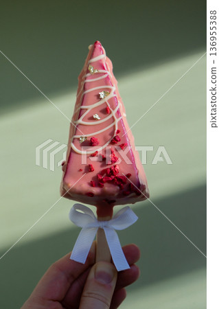 New look of trendy miniature ice cream cheesecake on stick in vibrant pink color on pastel background. Copy space mock up template sample for bakery mini dessert coffee shop. Cake to go takeaway sweet 136955388