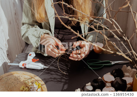 Female hands making egg shell handmade decoration for Easter holiday. Tutorial master class storytelling. Zero waste sustainable eco-friendly me made decor. Minimalistic 136955430