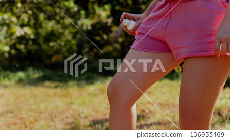 Young woman using insect sprays disease prevention. Protection against mosquito bite during summertime. Safety skin treatment 136955469