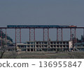 A DD51 locomotive and six old-style passenger cars cross the Amarube Viaduct overlooking the Sea of Japan. A railway heritage trestle bridge. 1986 archive. 136955847