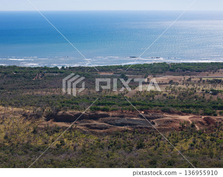 Sand quarry next to ocean beach 136955910