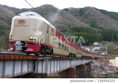 Sleeper express train Sunrise Izumo running on the Hakubi Line in spring Sleeper express train Sunrise Izumo running on the Hakubi Line in spring 136956325