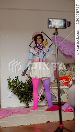 An energetic and colorful clothing presentation with smiling model 136956737