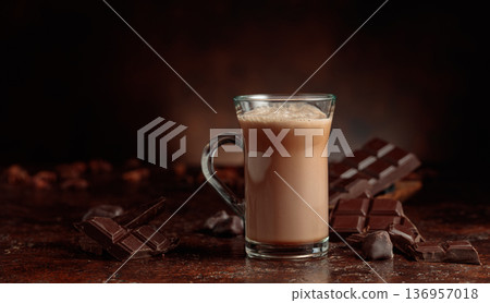 Cocoa drink in glass mug and pieces of bitter chocolate. Cocoa drink in glass mug and pieces of bitter chocolate. 136957018