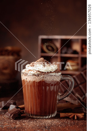 Hot chocolate topped with whipped cream and sprinkled with chocolate chips. Hot chocolate topped with whipped cream and sprinkled with chocolate chips. 136957026