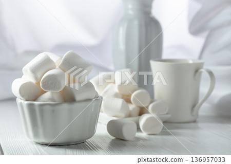 White marshmallows on a wooden table. White marshmallows on a wooden table. 136957033