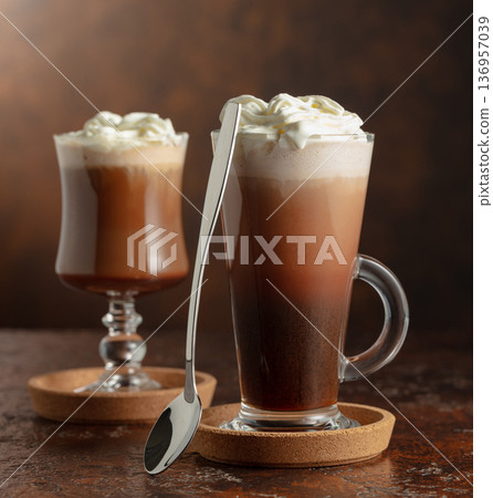 Creamy milk chocolate drinks with whipped cream. 136957039