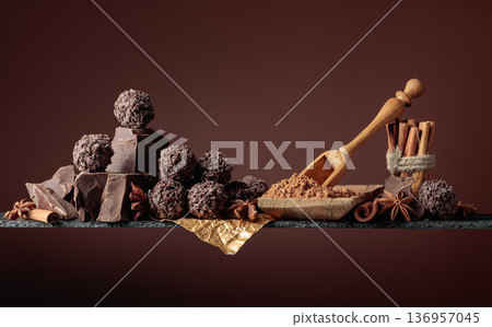 Chocolate truffles with broken pieces of chocolate and spices. 136957045