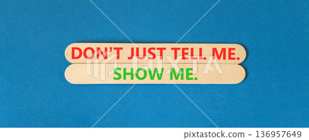 Tell or show symbol. Concept words Do not just tell me, show me beautiful wooden sticks. Beautiful blue background. Business tell or show concept. Copy space. Tell or show symbol. Concept words Do not just tell me, show me beautiful wooden sticks. Beautiful blue background. Business tell or show concept. Copy space. 136957649