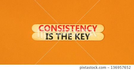 Consistency is the key symbol. Concept words Consistency is the key on beautiful wooden sticks. Beautiful orange background. Business consistency is the key concept. Copy space. 136957652
