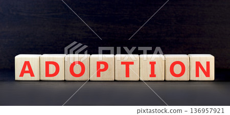 Adoption word symbol. Concept word Adoption on beautiful wooden blocks. Beautiful black background. Business psychological support help adoption word concept. Copy space. 136957921