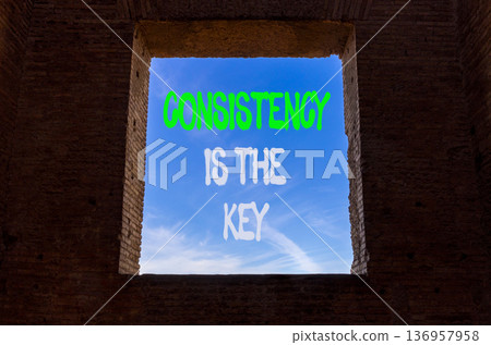 Consistency is the key symbol. Concept words Consistency is the key on beautiful window in ancient brick wall. Beautiful blue sky background. Business consistency is the key concept. Copy space. 136957958