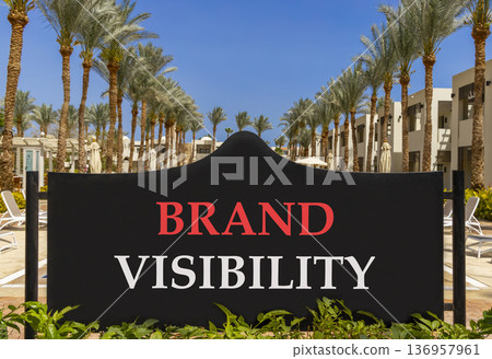 Brand visibility symbol. Concept words Brand visibility on beautiful big black road sign. Beautiful blue sky palm trees background. Business branding and brand visibility concept. Copy space. Brand visibility symbol. Concept words Brand visibility on beautiful big black road sign. Beautiful blue sky palm trees background. Business branding and brand visibility concept. Copy space. 136957961