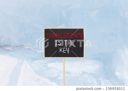 Consistency is the key symbol. Concept words Consistency is the key on beautiful blackboard. Beautiful blue Baikal ice background. Business consistency is the key concept. Copy space. 136958011