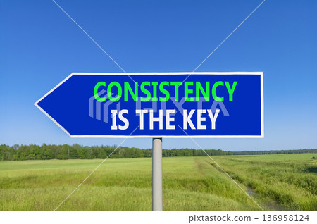 Consistency is the key symbol. Concept words Consistency is the key on beautiful blue road sign. Beautiful blue sky green field background. Business consistency is the key concept. Copy space. Consistency is the key symbol. Concept words Consistency is the key on beautiful blue road sign. Beautiful blue sky green field background. Business consistency is the key concept. Copy space. 136958124