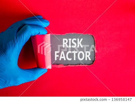 Risk factor symbol. Concept words Risk factor on beautiful grey paper. Doctor hand in blue medical glove. Beautiful red background. Medical healthy lifestyle risk factor concept. Risk factor symbol. Concept words Risk factor on beautiful grey paper. Doctor hand in blue medical glove. Beautiful red background. Medical healthy lifestyle risk factor concept. 136958147