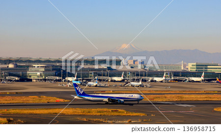 Mount Fuji seen from the observation deck of Haneda Airport's Terminal 1 and a domestic plane heading for takeoff Mount Fuji seen from the observation deck of Haneda Airport's Terminal 1 and a domestic plane heading for takeoff 136958715