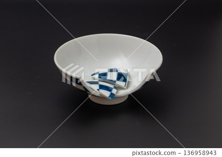 Broken rice bowl, Japanese tableware with a checkered pattern and a black background Broken rice bowl, Japanese tableware with a checkered pattern and a black background 136958943