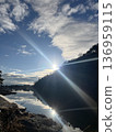 The sun reflecting on the surface of the water 136959115