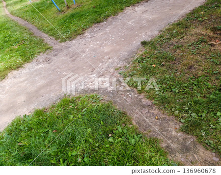 Earthen crossroads on the grass. Earthen crossroads on the grass. 136960678