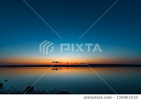 Sunrise at Gamou tidal flats, Sendai city, Miyagi prefecture. Reflections on the water surface. Sunrise at Gamou tidal flats, Sendai city, Miyagi prefecture. Reflections on the water surface. 136961010