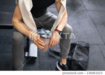 Man resting in gym after workout session Man resting in gym after workout session 136961023
