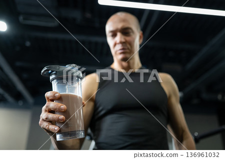 Man resting with towel after workout in gym Man resting with towel after workout in gym 136961032