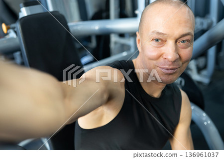 Man taking selfie after workout in fitness club Man taking selfie after workout in fitness club 136961037