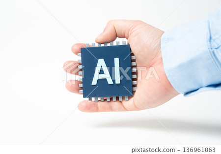 An AI chip in a hand. Breakthrough technologies with artificial intelligence. Digital innovation and smart automation. Future computing and high tech development An AI chip in a hand. Breakthrough technologies with artificial intelligence. Digital innovation and smart automation. Future computing and high tech development 136961063