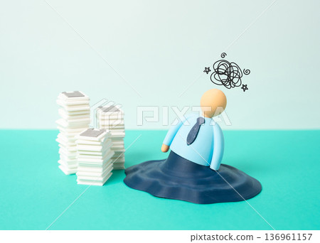 The office worker is metaphorically melting due to the large volume of work. Extreme fatigue and deadline pressure. Burnout syndrome and productivity crisis The office worker is metaphorically melting due to the large volume of work. Extreme fatigue and deadline pressure. Burnout syndrome and productivity crisis 136961157