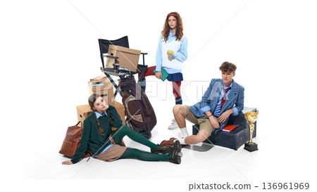 Teen students posing with books, storage boxes and trophy isolated on white. Teen students posing with books, storage boxes and trophy isolated on white. 136961969