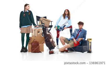 Teen students posing with boxes, golf bag and trophy isolated on white 136961971