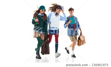Three teen students running with books isolated on white. 136961973