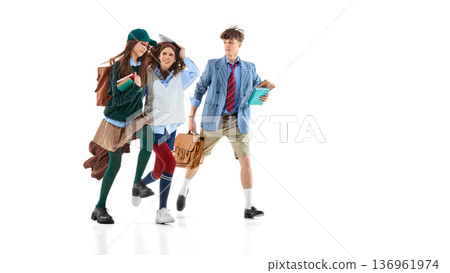 Teen students walking with books and backpacks isolated on white. 136961974