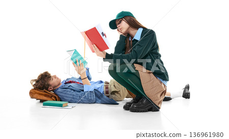 Teen students studying on floor with books isolated on white. 136961980