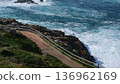 Scenic view of a coastal hiking trail with a wooden fence along the rocky Atlantic coast in A Coruna, Galicia, Spain.  136962169