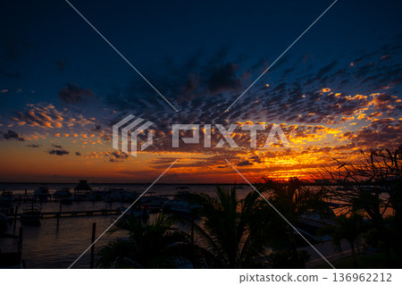 Spectacular mexican sunset over marina with boats and palms Spectacular mexican sunset over marina with boats and palms 136962212