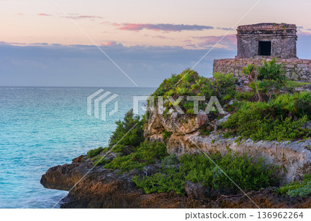 Mayan temple at sunset on tulum cliffs overlooking caribbean sea Mayan temple at sunset on tulum cliffs overlooking caribbean sea 136962264
