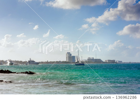 Turquoise waters with sailboat and yachts near coastal city Turquoise waters with sailboat and yachts near coastal city 136962286