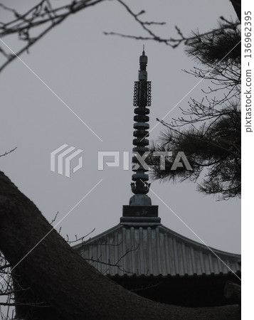 Close-up of the spire and roof of a five-story temple pagoda 136962395