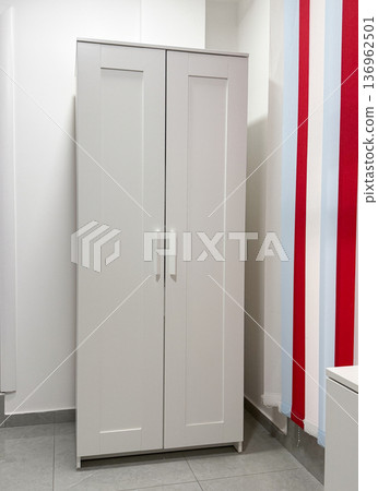 White wardrobe cabinet in modern minimalist interior. Storage solution, organization concept, home furniture design, clean aesthetic space 136962501