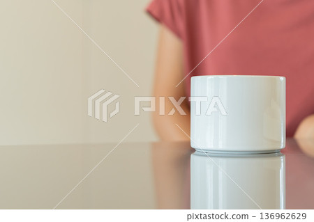 White Coffee Mug on Reflective Table with Blurred Background 136962629