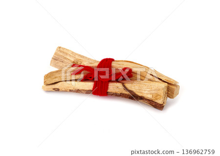 a bundle of sandalwood sticks tied with red yarn 136962759