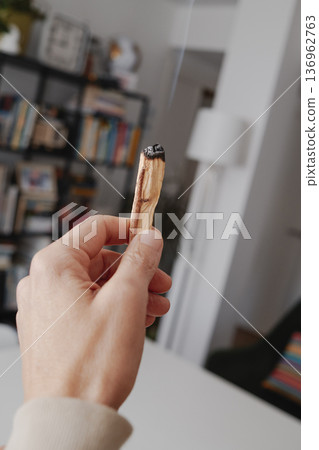 a man purifies a room with sandalwood smoke 136962763