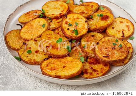 Crispy potato slices, with parmesan cheese and spices, fried in the oven, homemade, no people, Crispy potato slices, with parmesan cheese and spices, fried in the oven, homemade, no people, 136962971