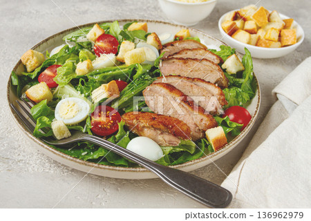 Caesar salad, with duck breast, on a light plate, on a light background, homemade, no people, Caesar salad, with duck breast, on a light plate, on a light background, homemade, no people, 136962979