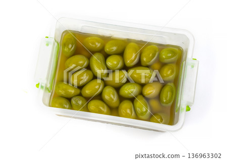 Olives Stored in a Container With Brine on a Simple White Background 136963302