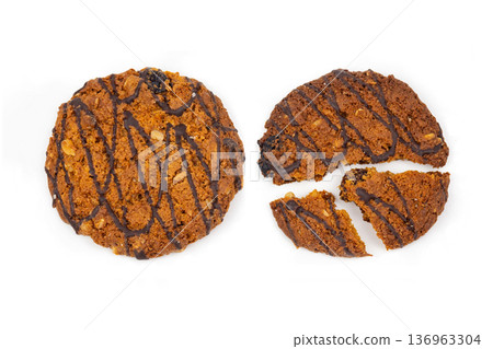 Three Cookies With Chocolate Drizzle Arranged on a White Background During a Bright Daylight Setting Three Cookies With Chocolate Drizzle Arranged on a White Background During a Bright Daylight Setting 136963304