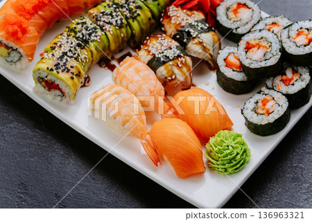 Assorted sushi platter with rolls nigiri salmon shrimp and wasabi on white plate Assorted sushi platter with rolls nigiri salmon shrimp and wasabi on white plate 136963321